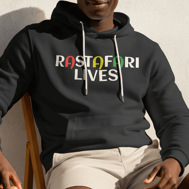 Person wearing a black hoodie with 'RASTAFARI LIVES' text, sitting against a light-colored wall.
