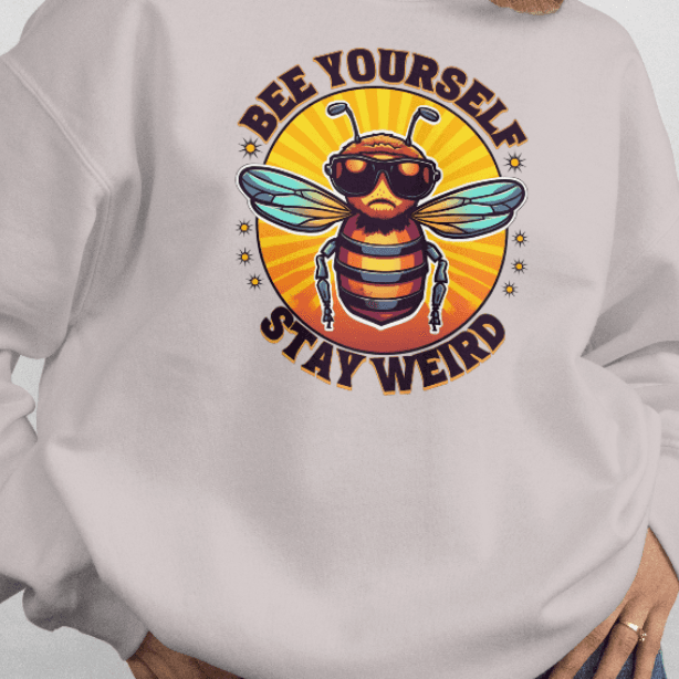 Person wearing a light gray sweatshirt with a bee graphic and text on a white background