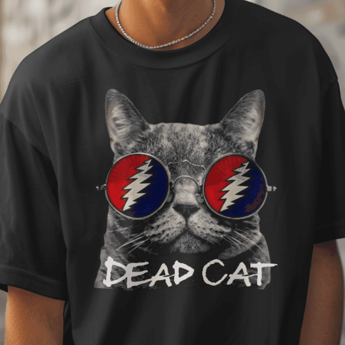 Person wearing a black t-shirt with a cat graphic and 'DEAD CAT' text in an urban setting.