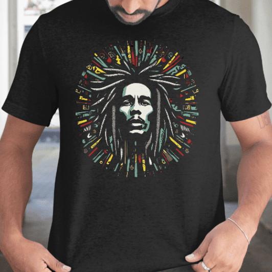 A man wearing a black t-shirt with a colorful reggae-inspired graphic design of a face.